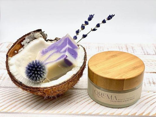 Qrema CALM Face & Body Balm - Qrema Enter a state of heavenly bliss with our Coconut Lavender scented face & body balm. Buttery Coconut softens rough skin and Lavender essence calm the mind and spirit.  Calm has properties that are soothing, relaxing, relieves pain. It can help ease muscles, joint pain, sprains and backache.  Ingredients: shea butter, mineral oils, fragrance essential oil and natural powder.  *Contains Tree Nuts 4 oz glass container with bamboo lid.