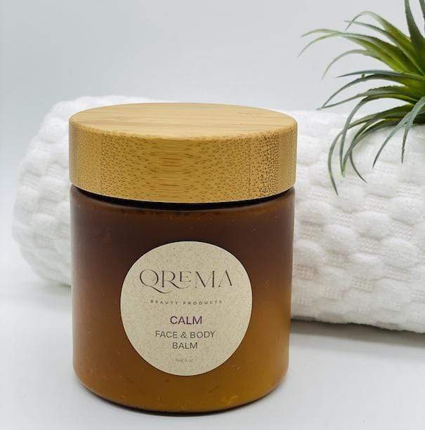 Qrema CALM Face & Body Balm - Qrema Enter a state of heavenly bliss with our Coconut Lavender scented face & body balm. Buttery Coconut softens rough skin and Lavender essence calm the mind and spirit.  Calm has properties that are soothing, relaxing, relieves pain. It can help ease muscles, joint pain, sprains and backache.  Ingredients: shea butter, mineral oils, fragrance essential oil and natural powder.  *Contains Tree Nuts 8 oz bpa free container with bamboo lid.